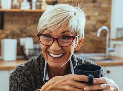 Older woman smiling with dental implants