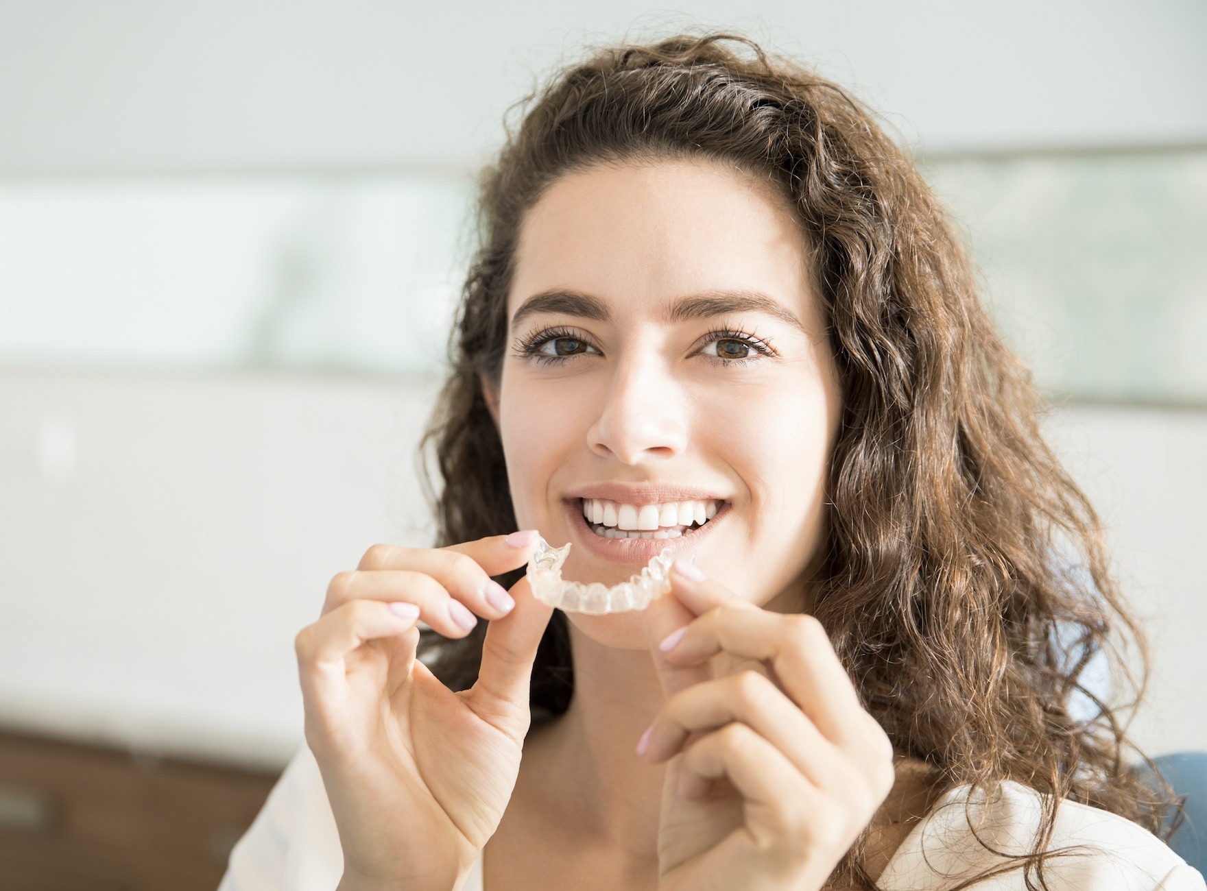 Woman with Invisalign teeth straightening tray