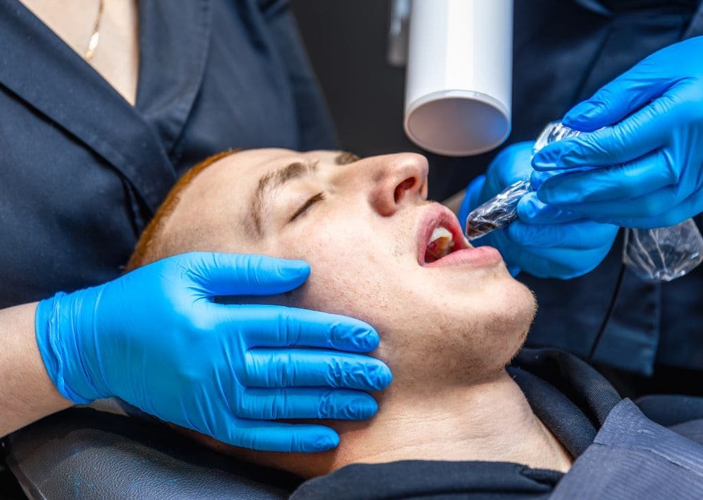 Man getting a quick pain relief at an emergency dentist in Ipswich.