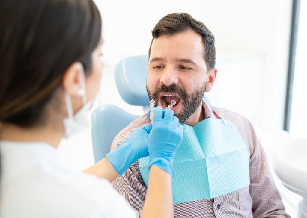 Man checking his teeth for a potential dental emergency in Ipswich.
