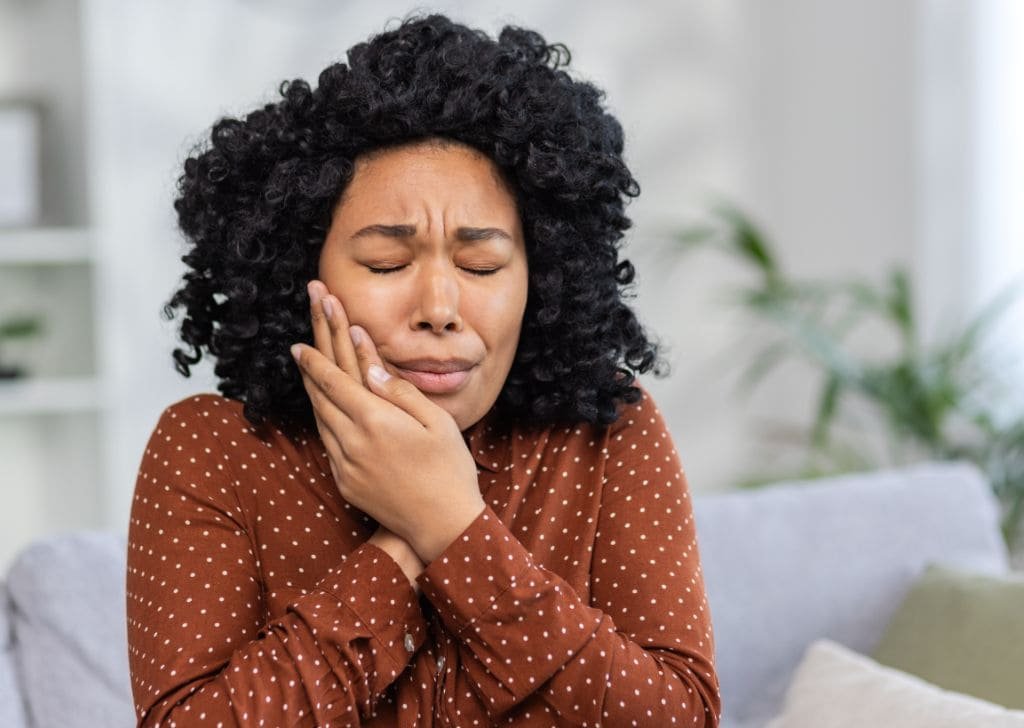 Woman getting a Toothache before visiting an emergency dentist in Ipswich.